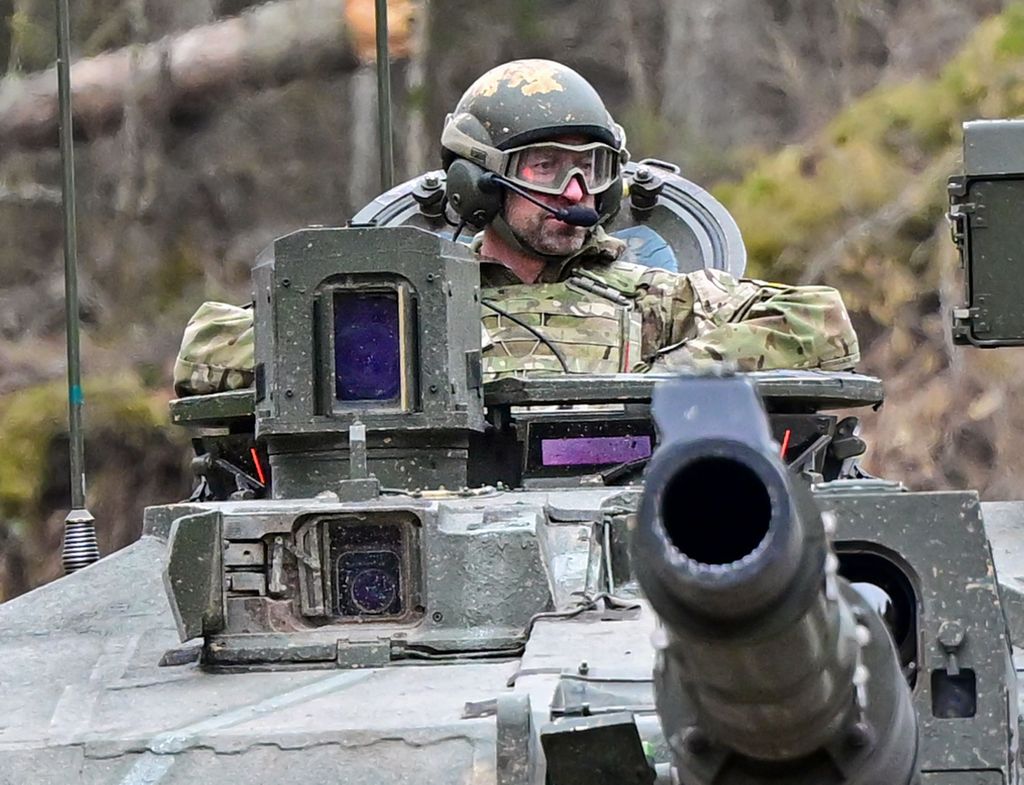 Prince William riding in a Challenger 2 battle tank