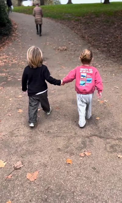 Two young boys walking hand-in-hand