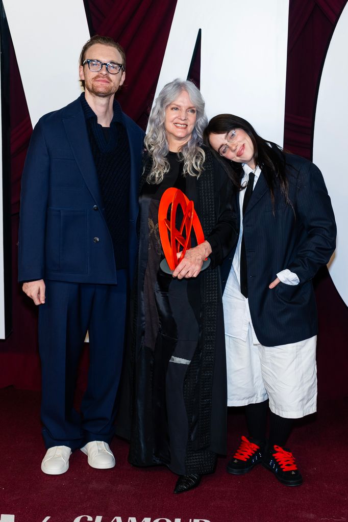 Billie eilish with her brother and mother on the red carpet