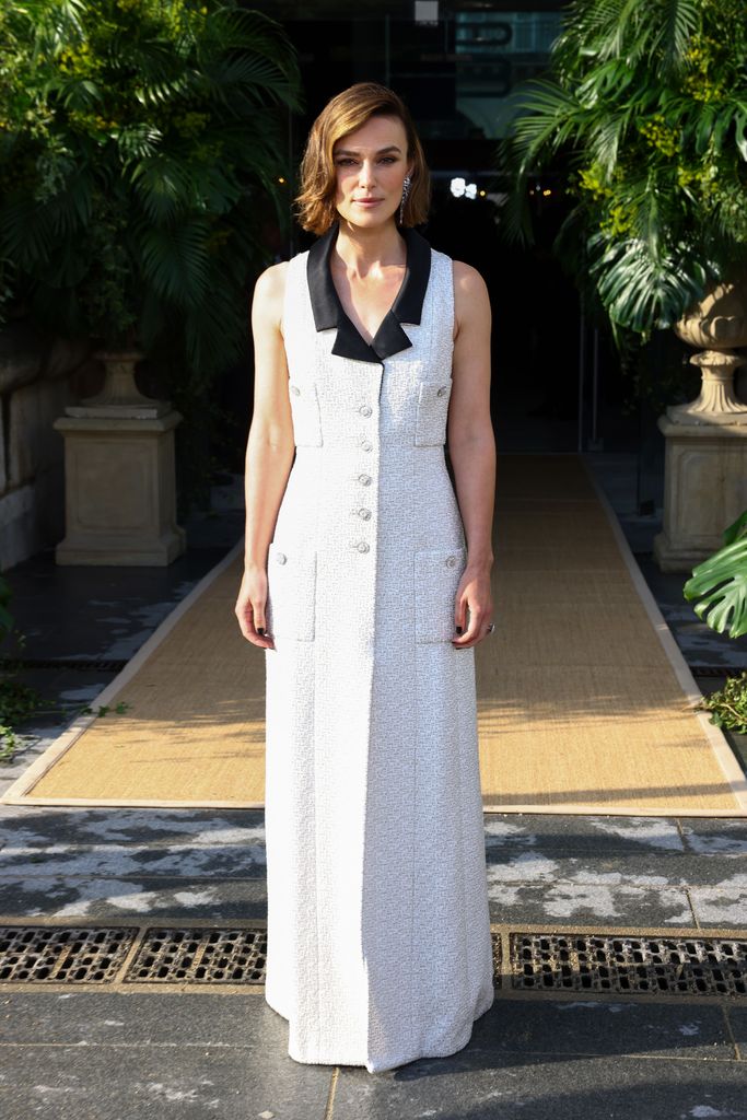 Keira Knightley during the Bal D'Ete in Paris wearing a white tweed full length gown with black collar detailing and silver buttons