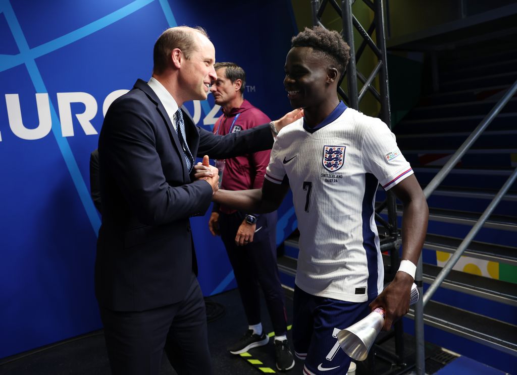 Prince William, Prince of Wales, congratulates Bukayo Saka of England in the tunnel following victory in the penalty shoot-out during the UEFA EURO 2024 quarter-final match