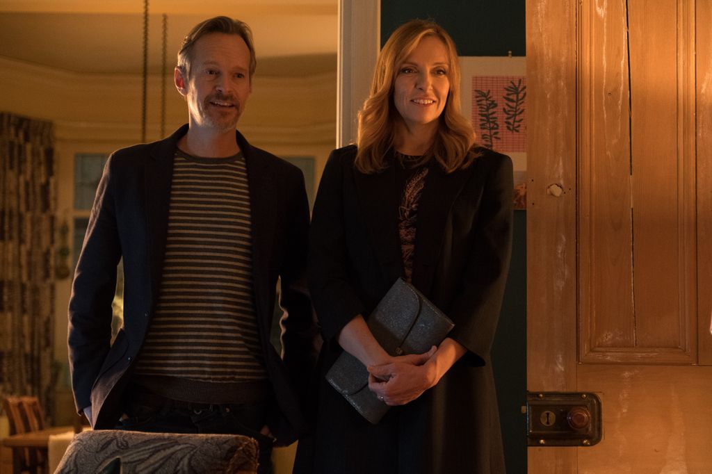man and woman standing in dimly lit room