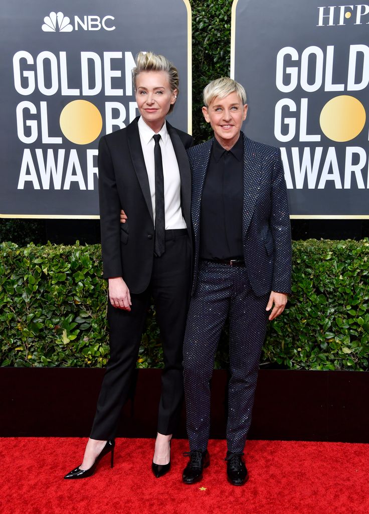 Portia de Rossi in a black suit and Ellen DeGeneres in a sparkly grey suit attend the 77th Annual Golden Globe Awards 2020