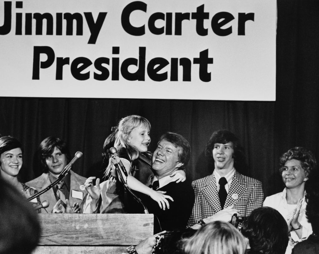 Jimmy Carter, Governor of Georgia, holds up his daughter Amy as he announced that he is to seek the Democratic presidential nomination, Atlanta, Georgia, December 12th 1974.