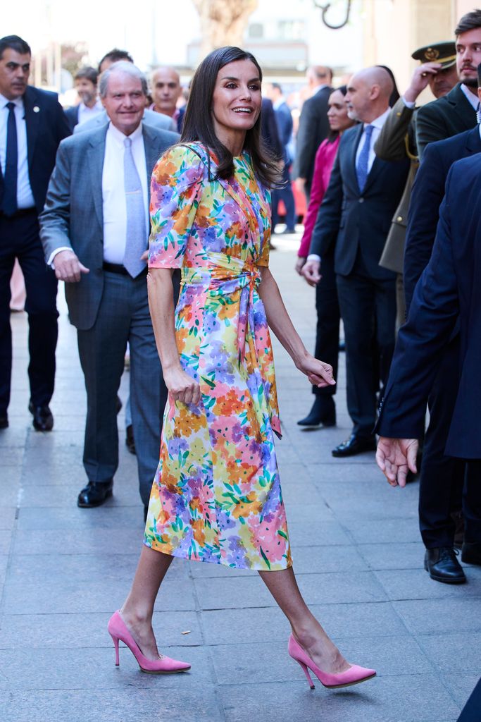 Queen Letizia walking in bright spring florals dress 