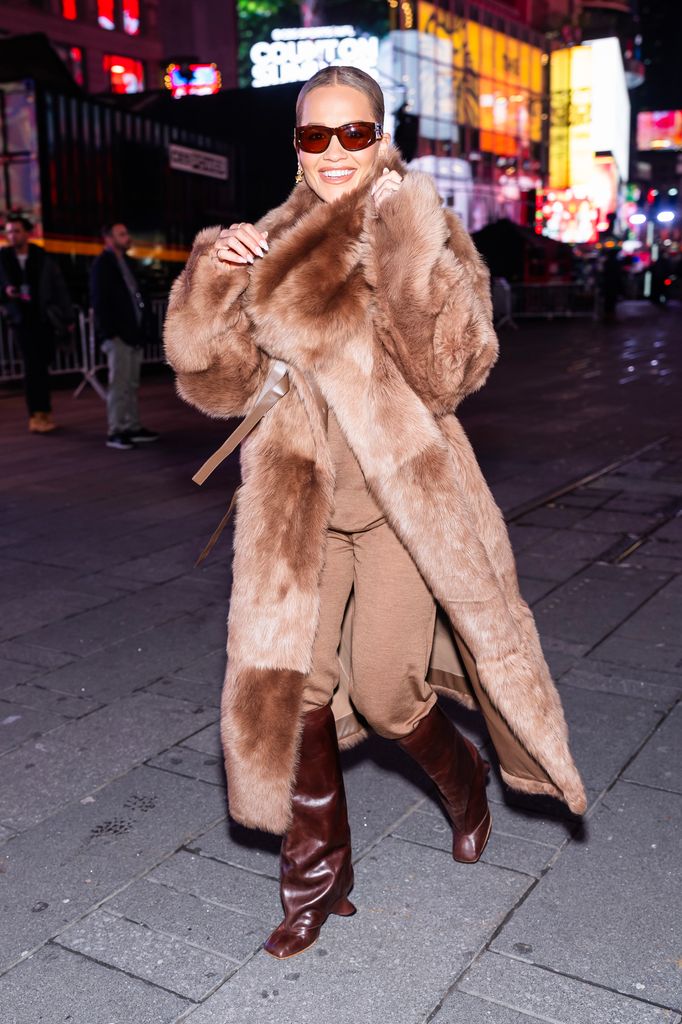 Rita Ora in New York City at night in tan fur coat