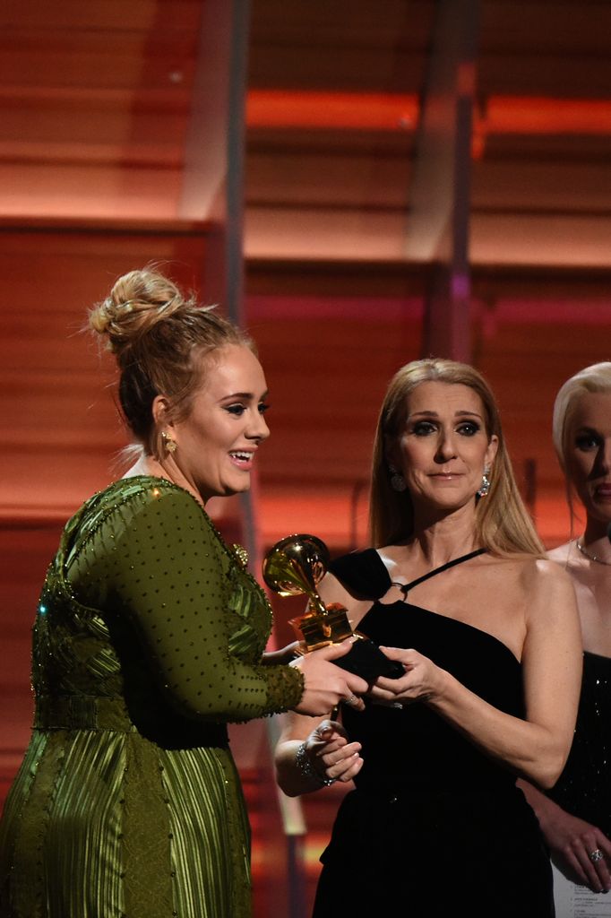 Adele receives the Grammy for best song of the year from Celine Dion (R) during the 59th Annual Grammy music Awards on February 12, 2017, in Los Angeles, California