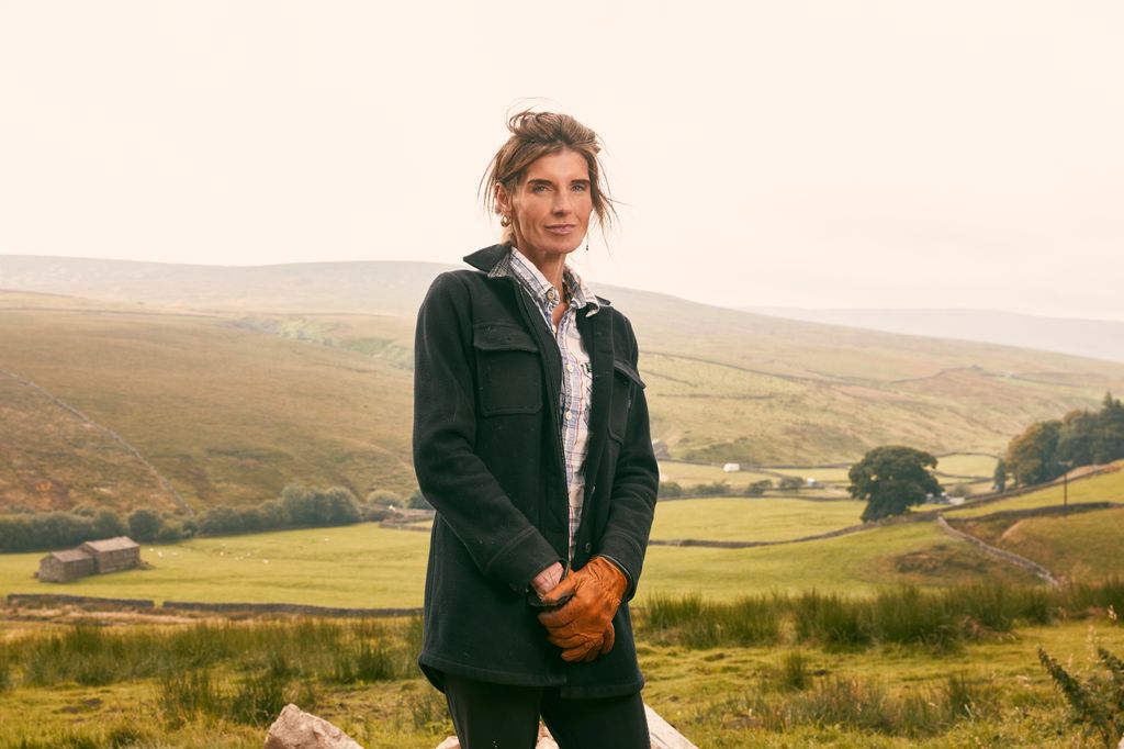 woman standing in front of rolling yorkshire hills