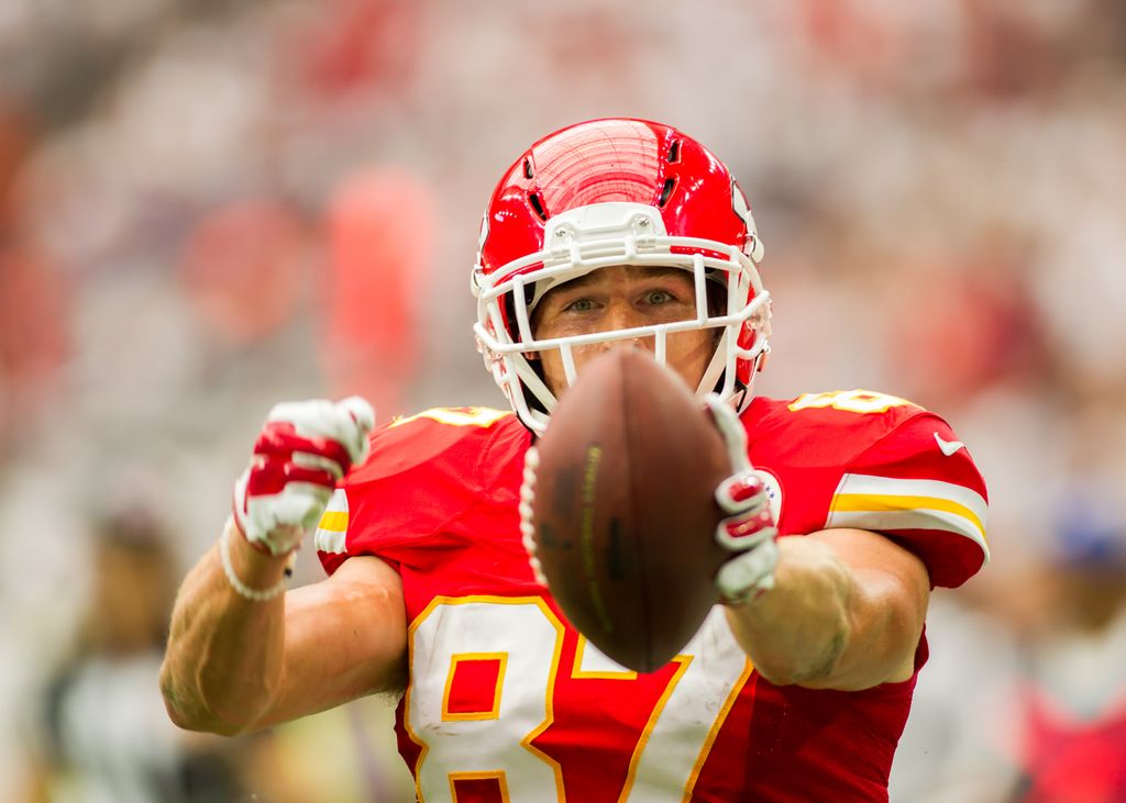 Travis Kelce holding a football 
