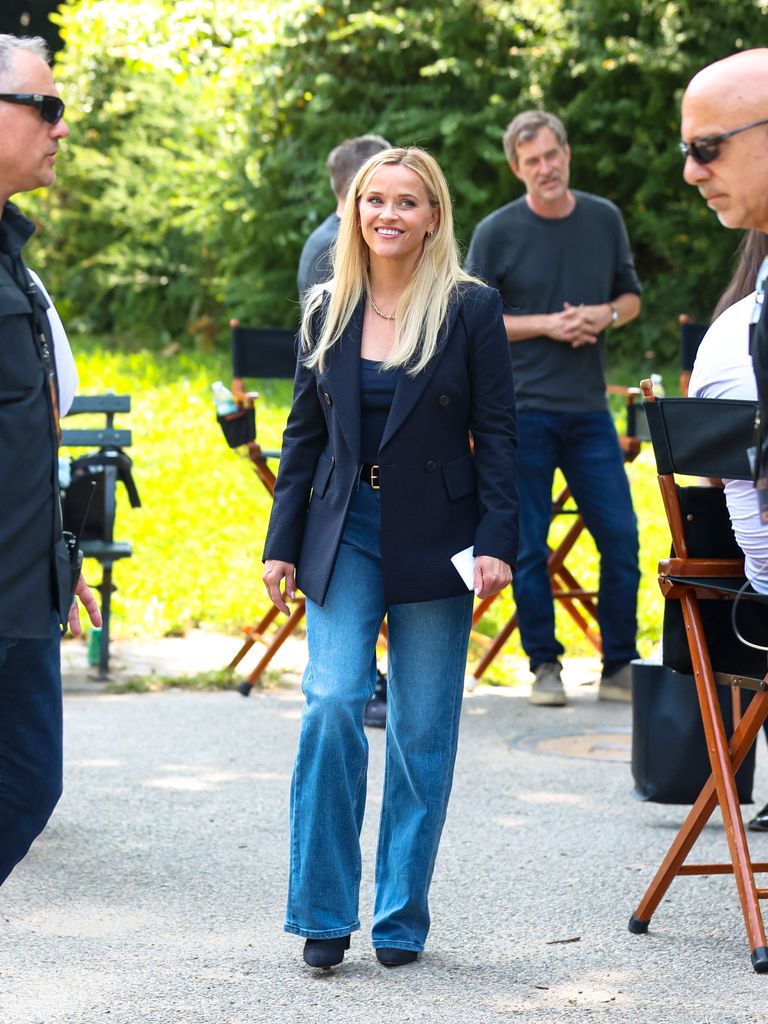 Reese Witherspoon in jeans and black blazer in park