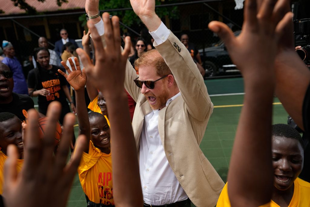  Prince Harry, chants with children during the Giant of Africa Foundation at the Dream Big Basketball clinic in Lagos Nigeria, Sunday, May 12, 20