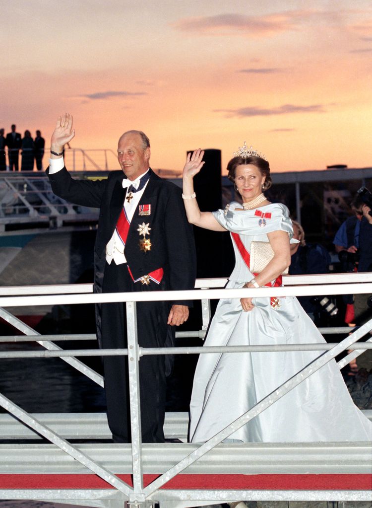 King Harald and Queen Sonja boarding boat in formal dress