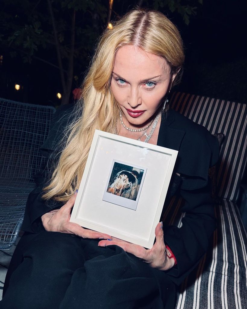 Madonna showing off a gift she'd received from manager Guy Oseary