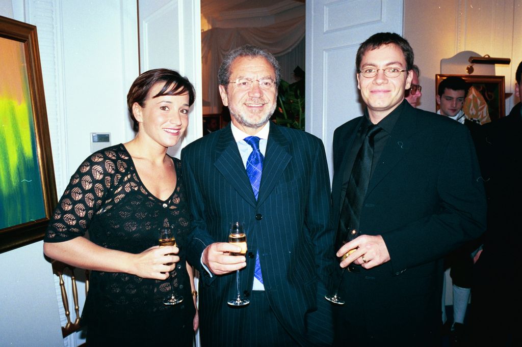 Man in suit standing with a younger woman and younger man