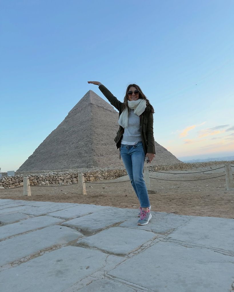 woman posing in front of pyramid