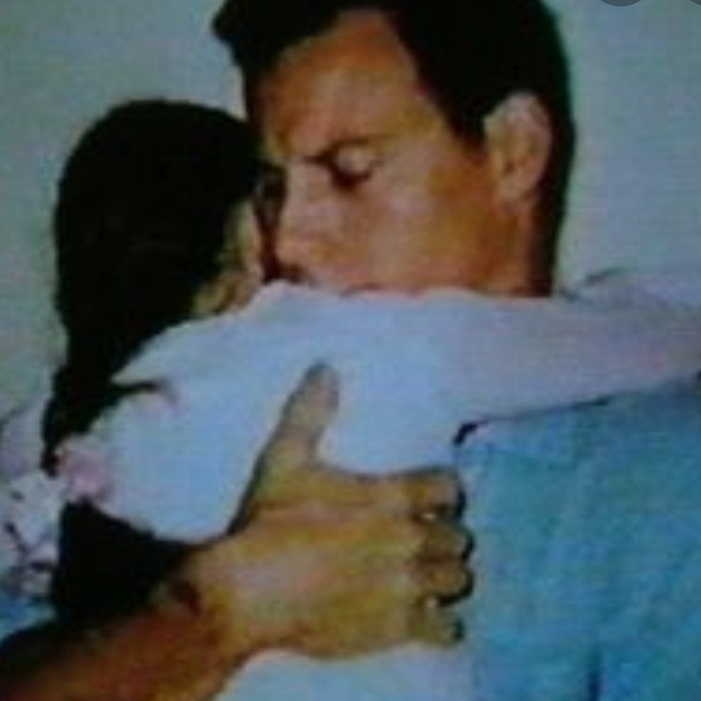 Erik Menendez holding his stepdaughter Talia in prison