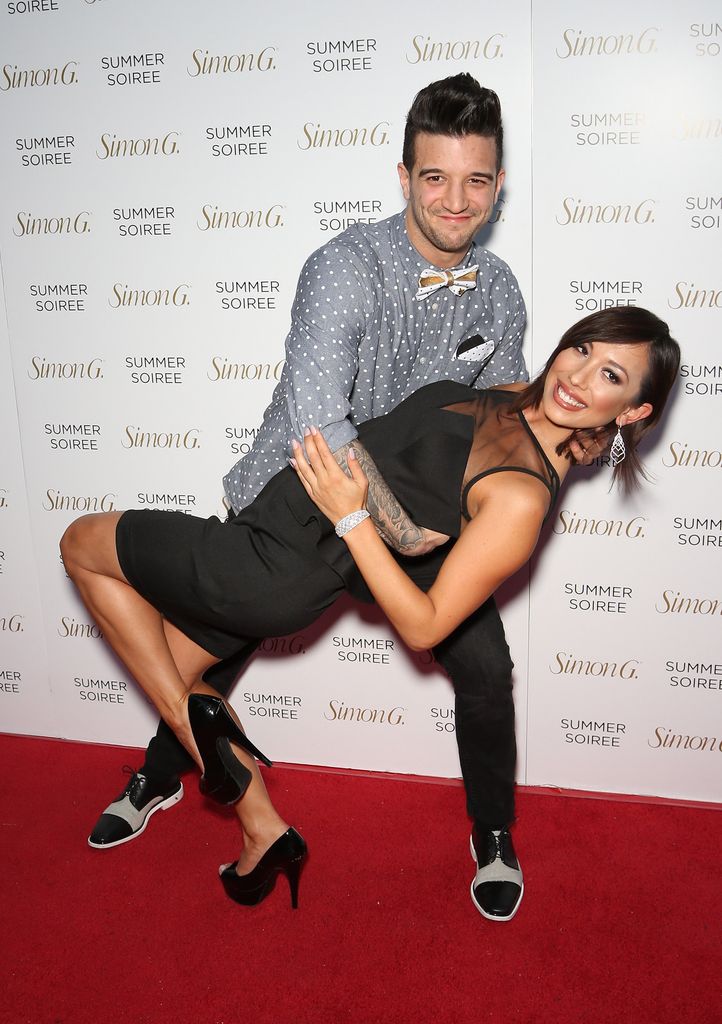 Mark Ballas (L) and dancer/model Cheryl Burke perform a dance move as they arrive at the Simon G Soiree at the Four Seasons Hotel Las Vegas on May 31, 2014
