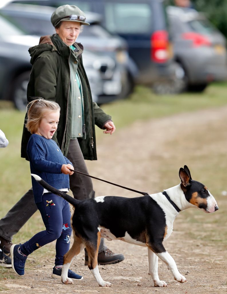 Princess Anne walking with Mia Tindall who is walking a dog