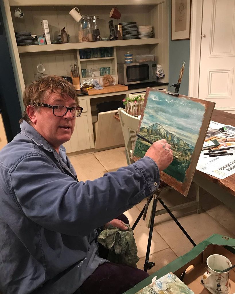 Gogglebox star Giles painting in a kitchen area
