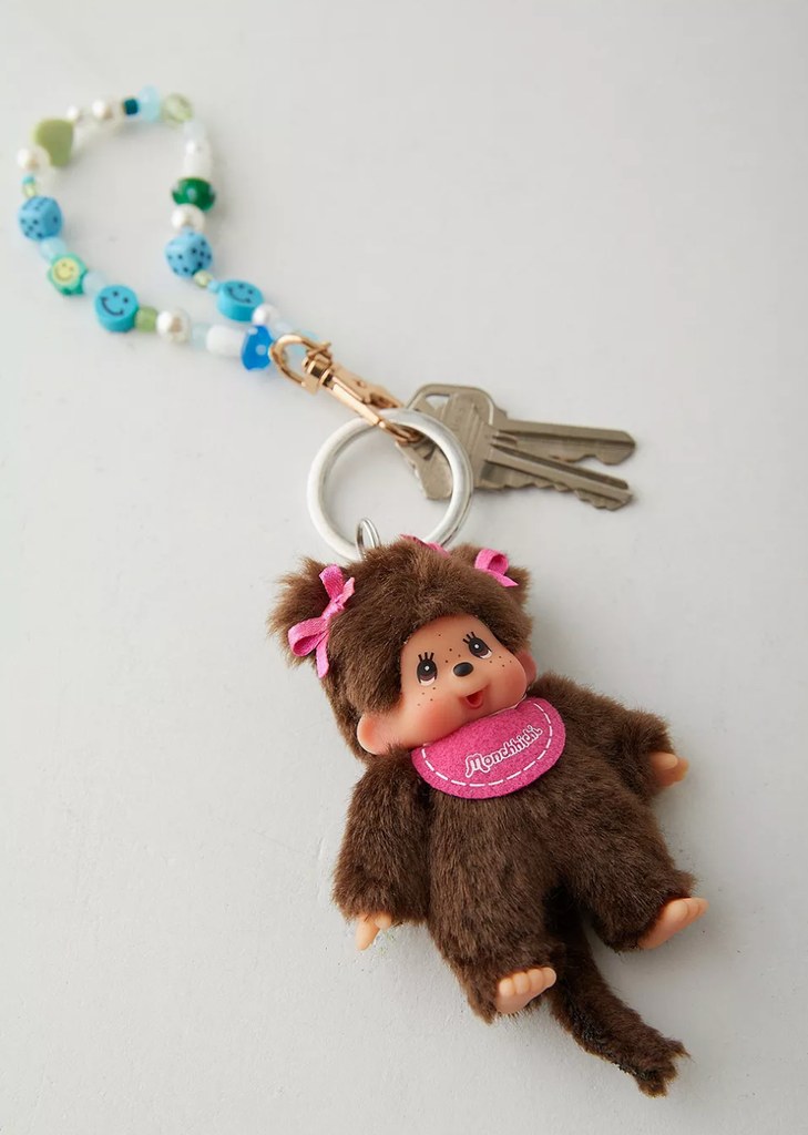 a Monchhichi keychain photographed on a white backgorund