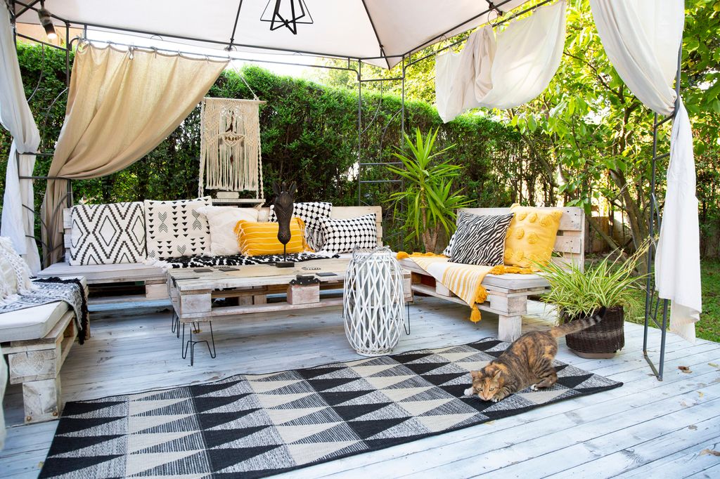 Monochrome garden furniture with cat in beautiful garden