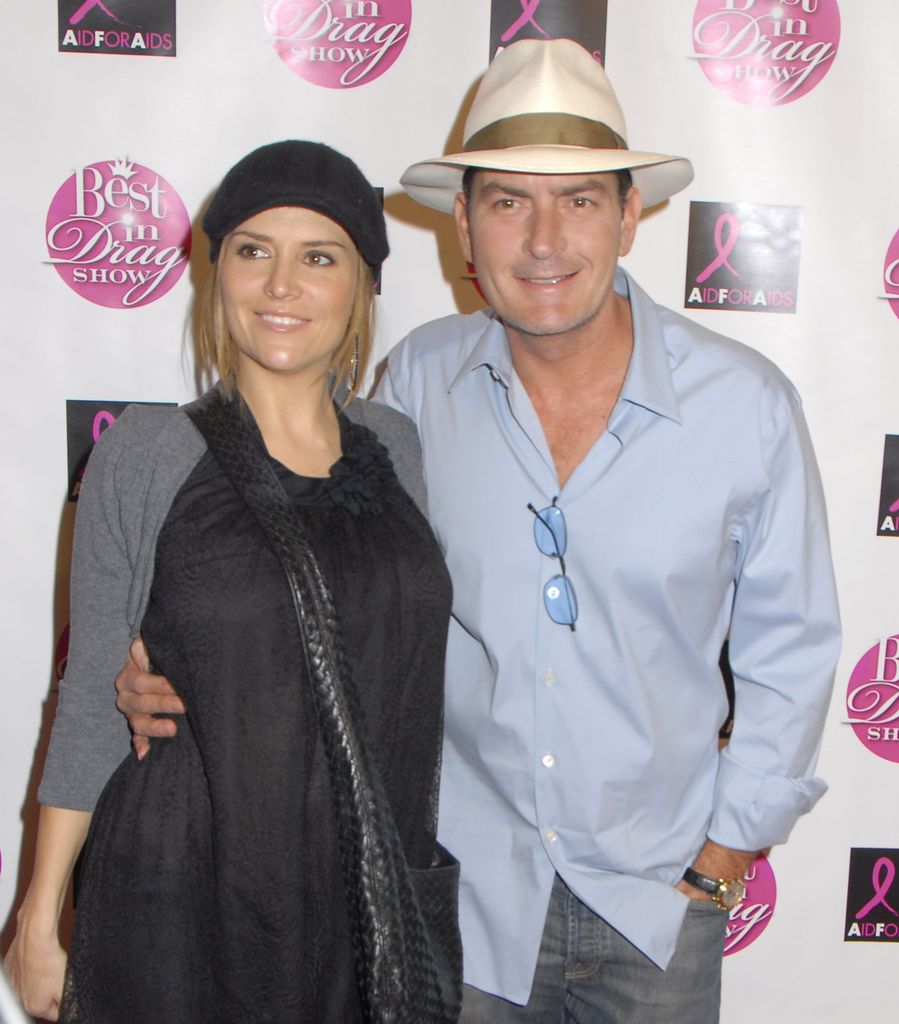  Charlie Sheen in blue shirt and hat and Brooke Mueller in black dress in 2008