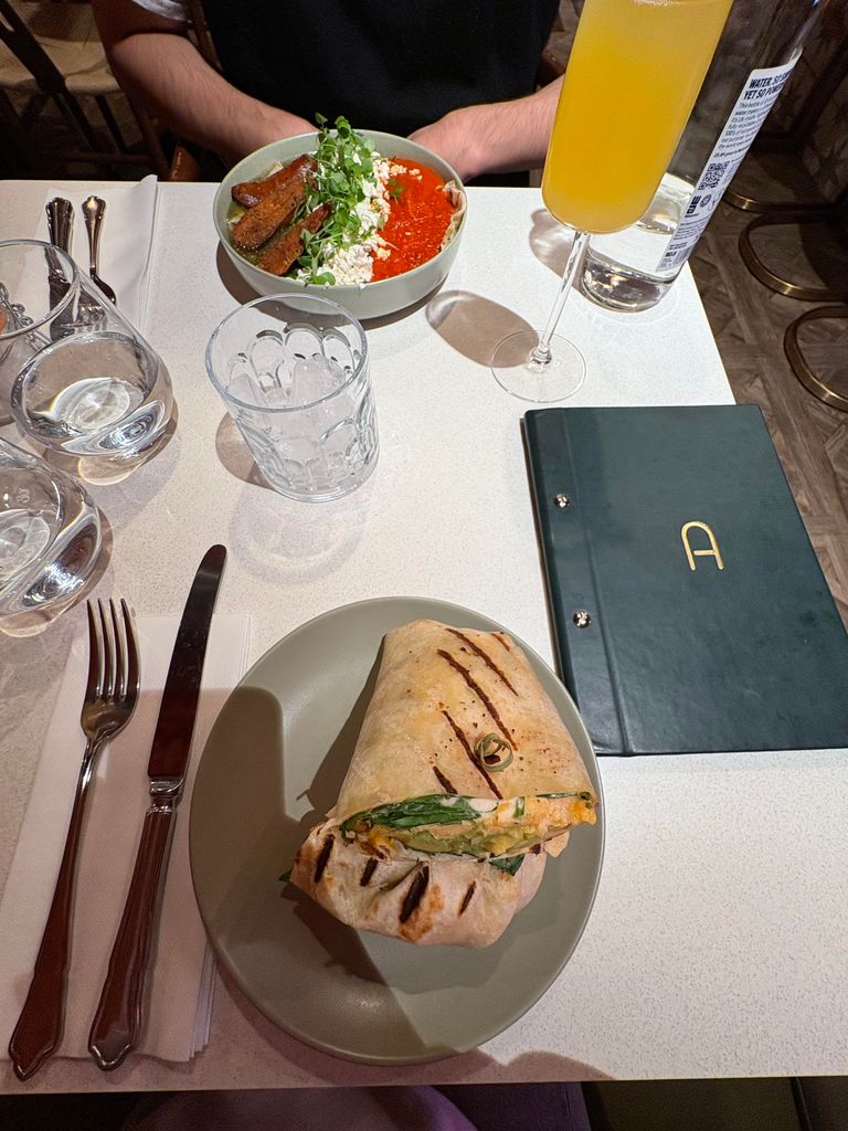 Breakfast burrito, a cocktail and another mexican dish