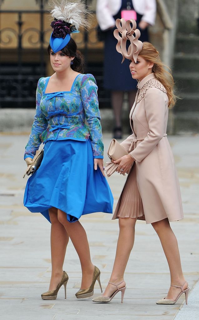 Princess Eugenie in blue floral dress and hat beside beatrice in nude dress and hat