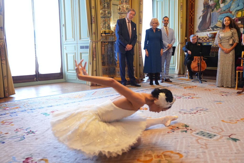 Queen Camilla, Patron of the English National Ballet, watches Sangeun Lee perform during a reception