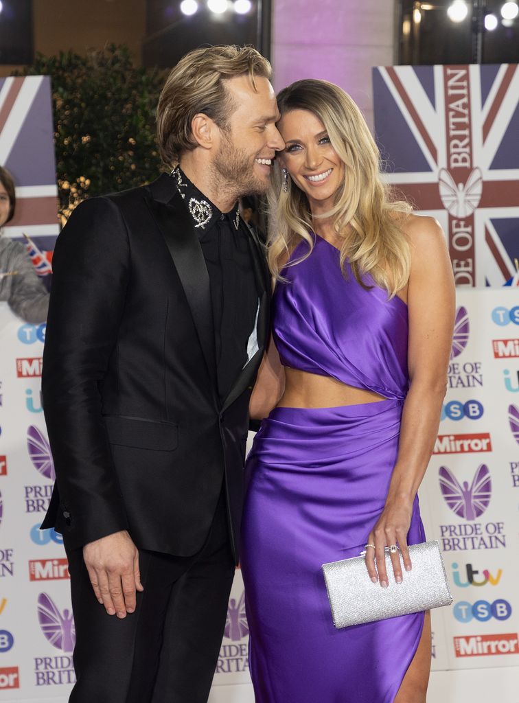Olly Murs leaning close to Amelia Tank in a purple dress at the Pride of Britain Awards 2022