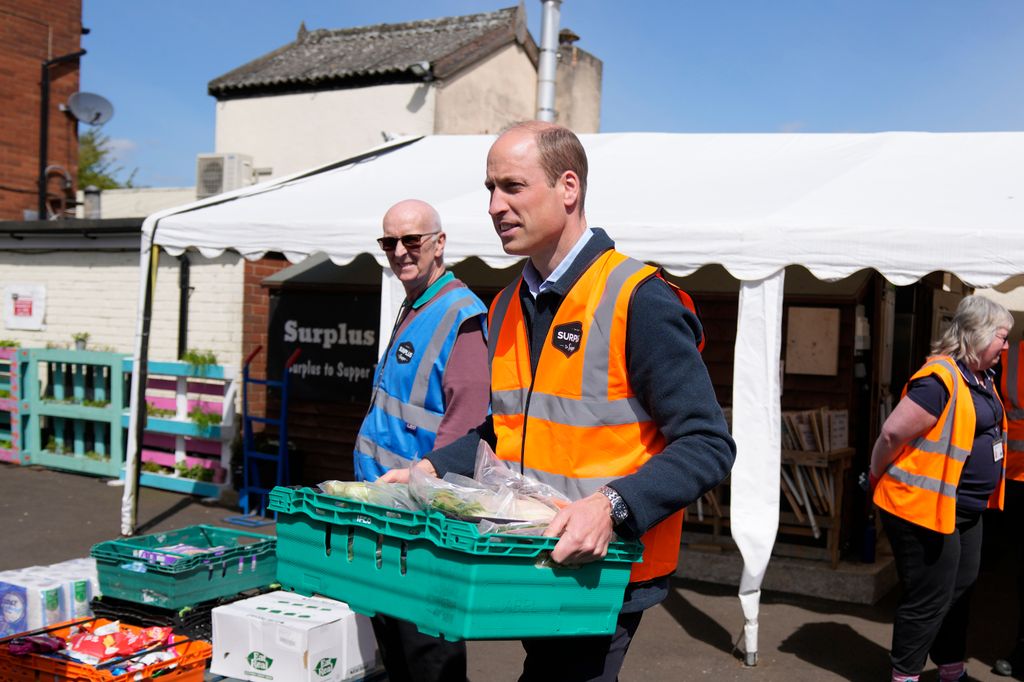 William  helps to load trays of food into vans