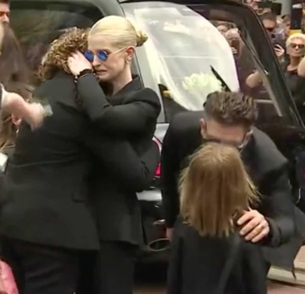 Jack Osbourne comforting his daughter