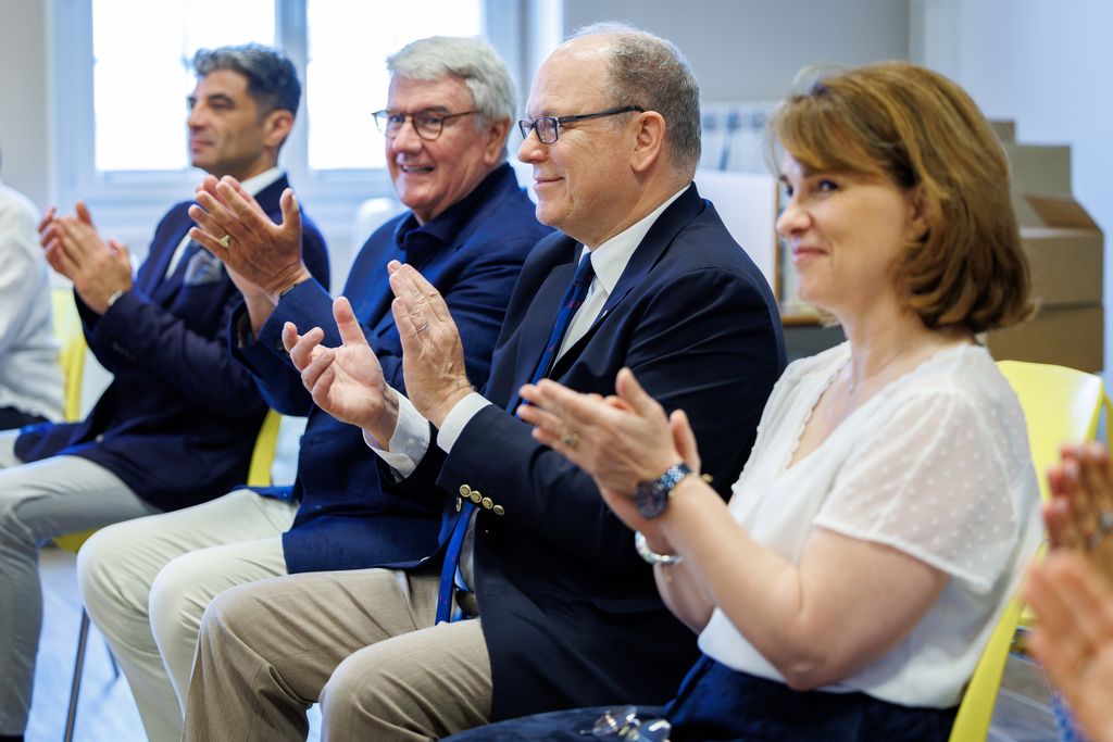 Prince Albert and three adults applauding
