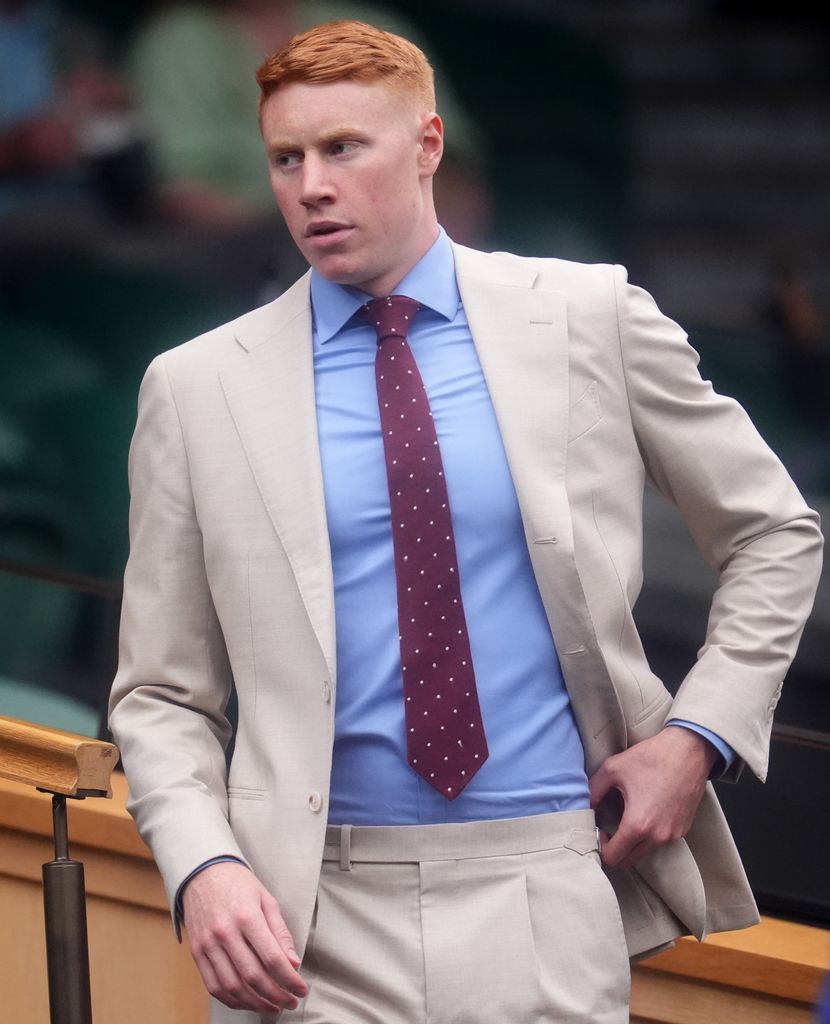 Tom Dean in the Royal Box in suit with blue shirt