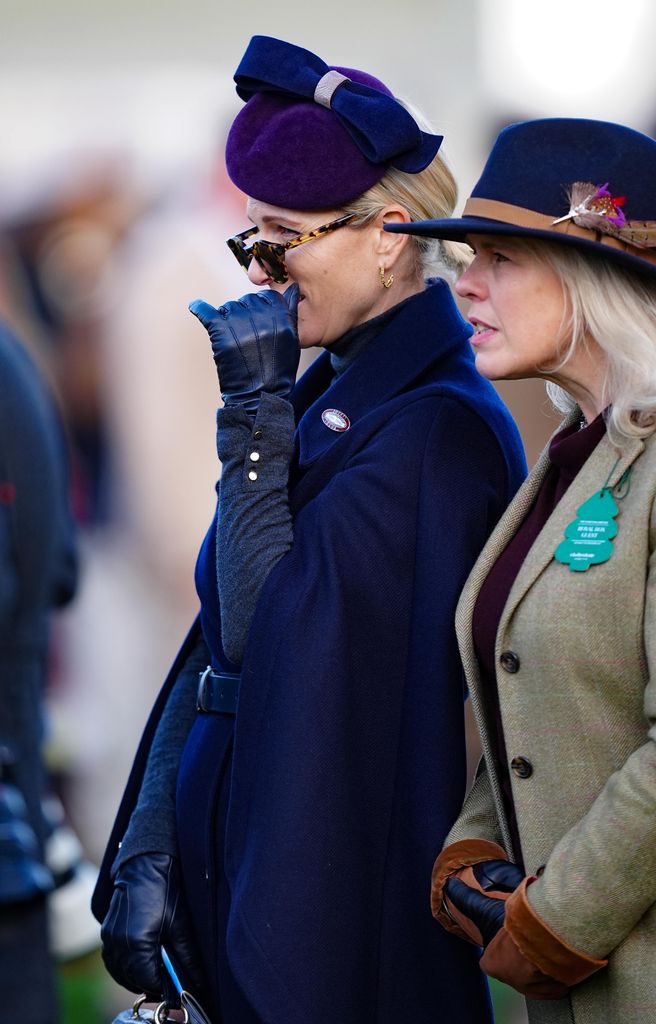 Zara Tindall side on in caped coat, hat and sunglasses