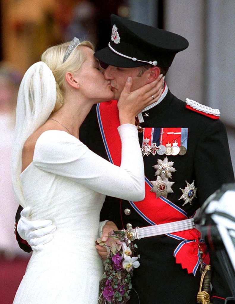 Crown Prince Haakon and Mette-Marit Tjessem Hoiby kiss at Oslo Cathedral