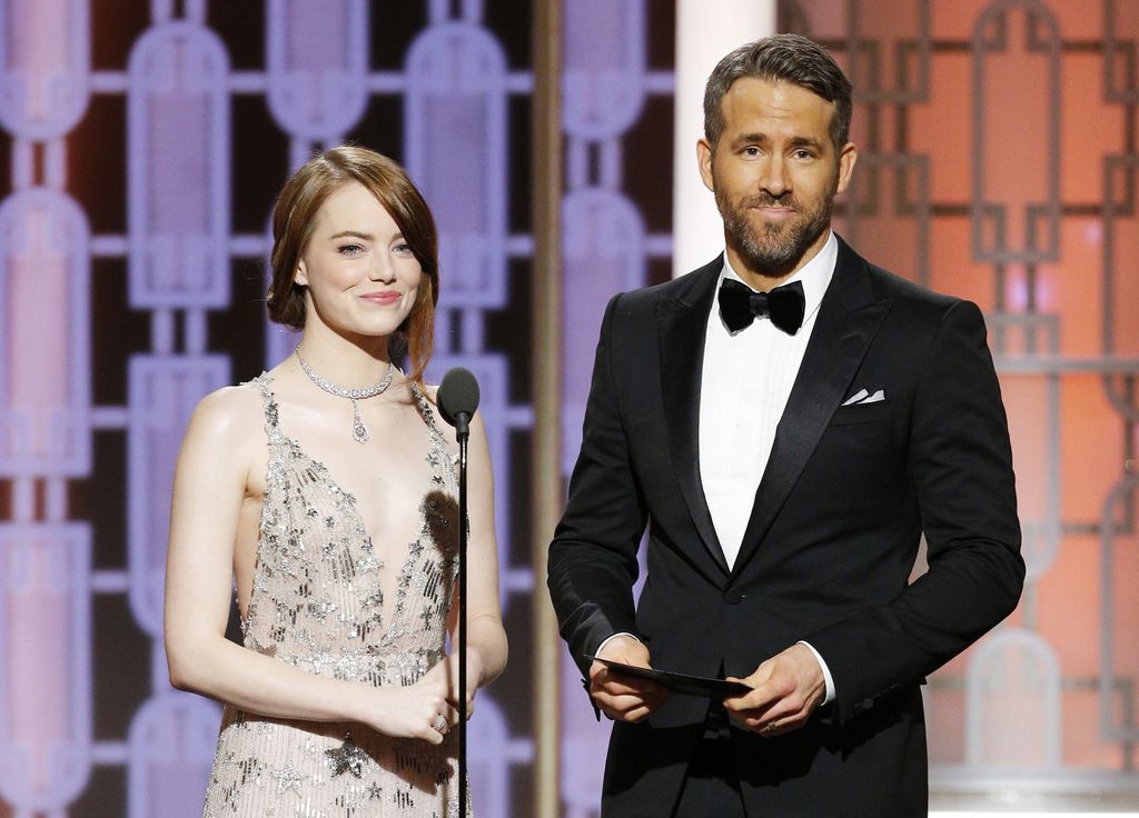 In this handout photo provided by NBCUniversal, presenters Emma Stone and Ryan Reynolds onstage during the 74th Annual Golden Globe Awards at The Beverly Hilton Hotel on January 8, 2017 in Beverly Hills, California.