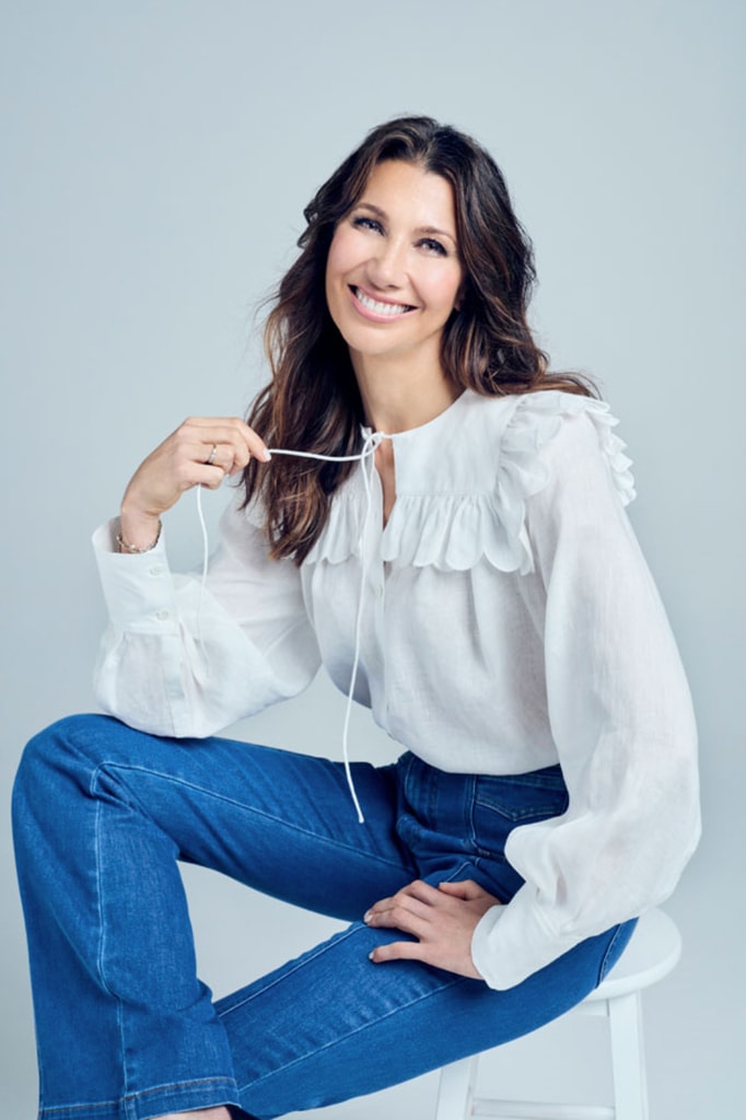 brunette midlife woman in white shirt and jeans
