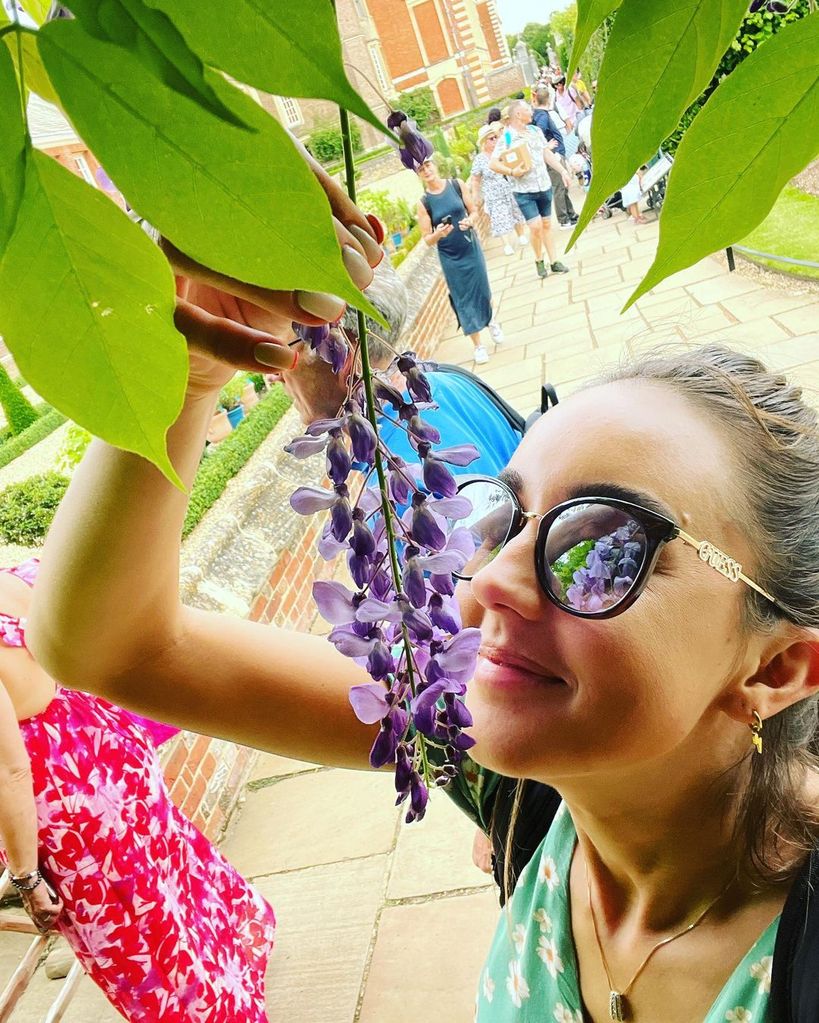 Emily Andre smells wisteria at Hampton Court Flower Show