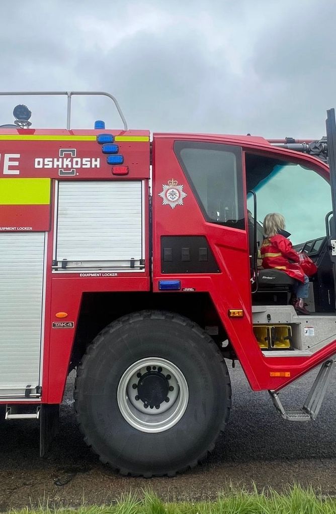 Wilf Johnson sitting in a fire engine 