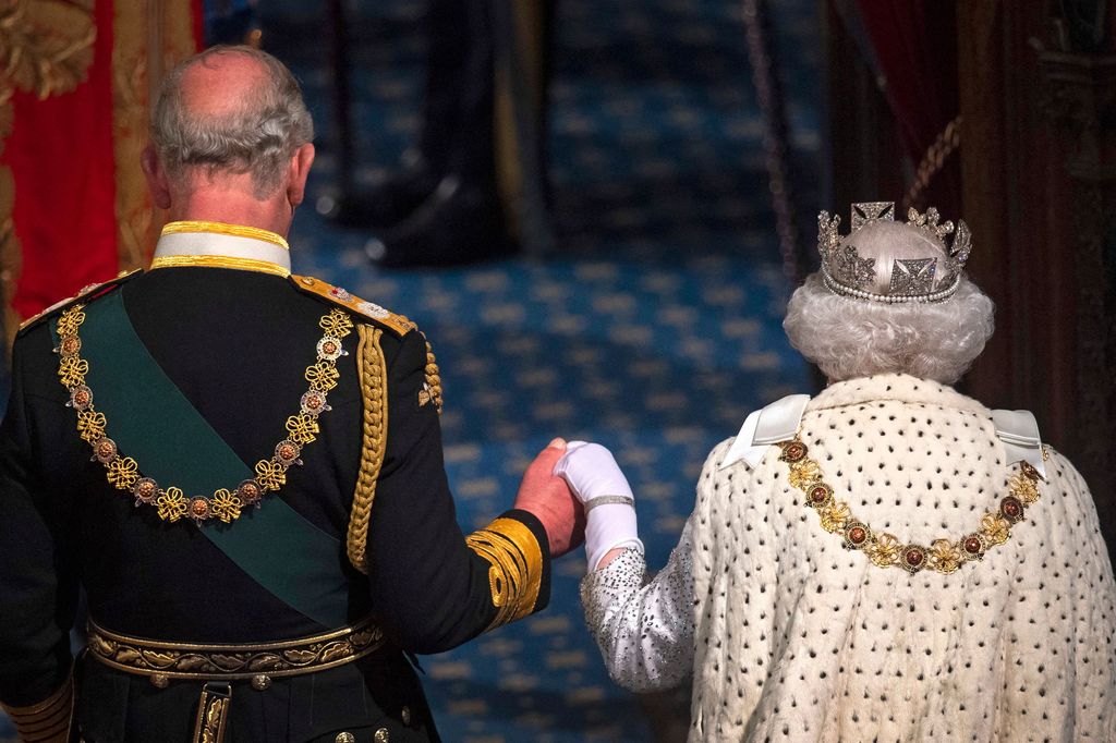 Prince Charles holds hands with Queen Elizabeth II