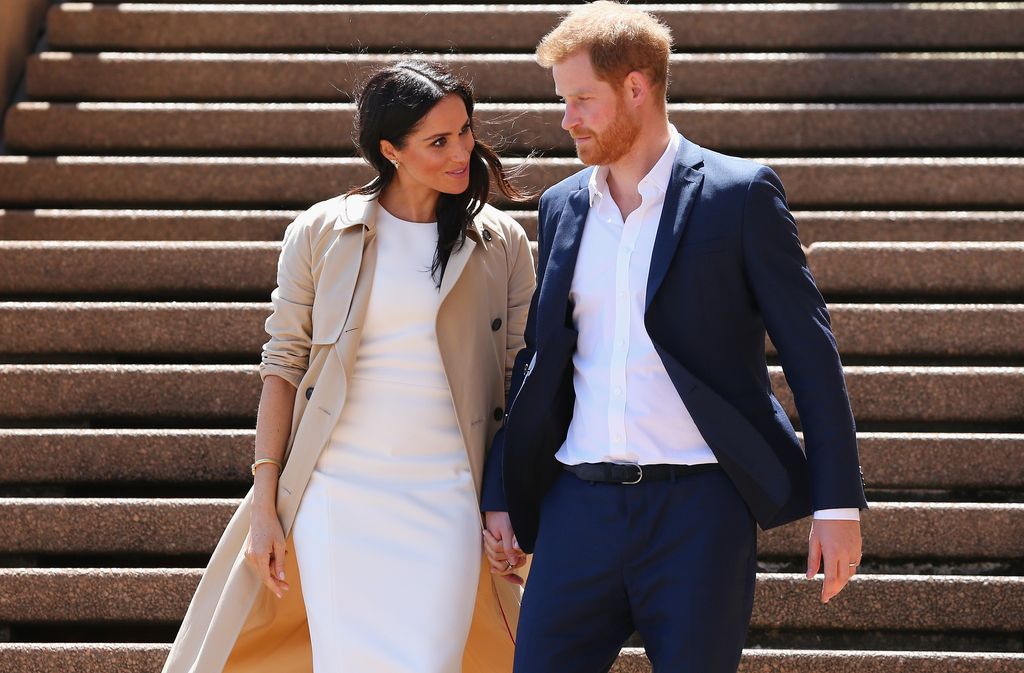 Prince Harry talking to Meghan Markle at the Sydney Opera House