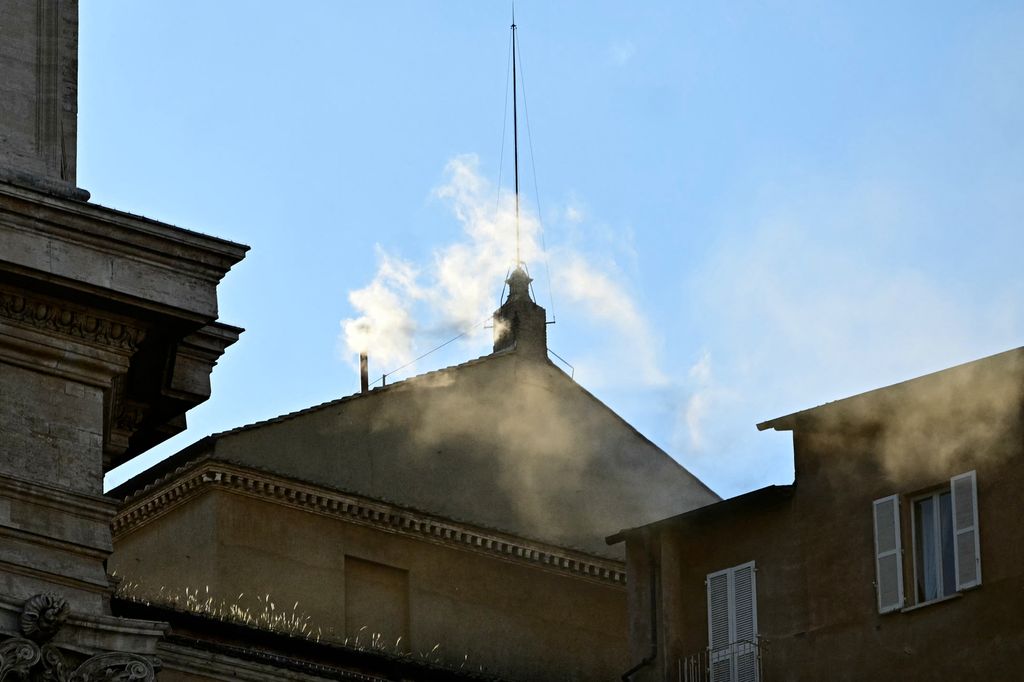 White smoke rising from the chinmey of the Sistine Chapel signaling that cardinals elected a new pope on May 8, 2025