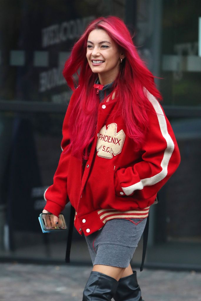 Dianne walking in red jacket with pink streaks in hair