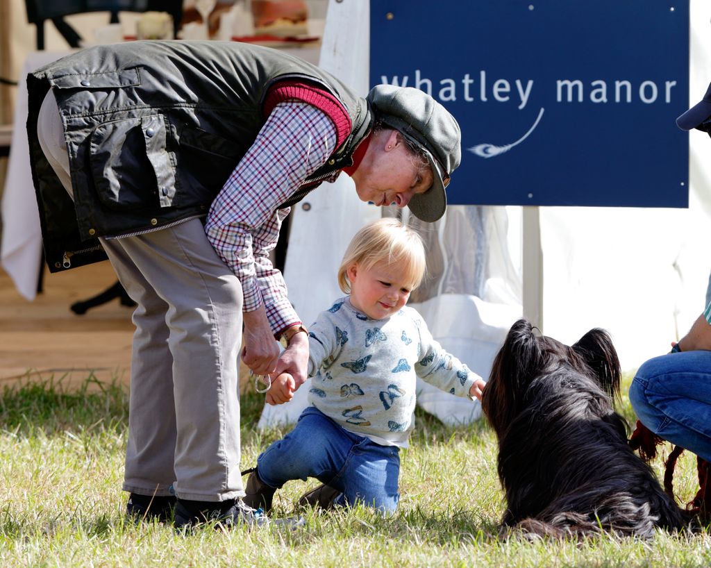 Princess Anne and Mia Tindall stroke a dog