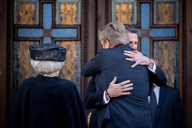 King Willem Alexander hugging Prince Pavlos of Greece as former Queen Beatrix looks on