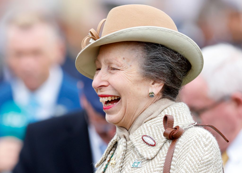 Princess Anne laughing in a smart hat