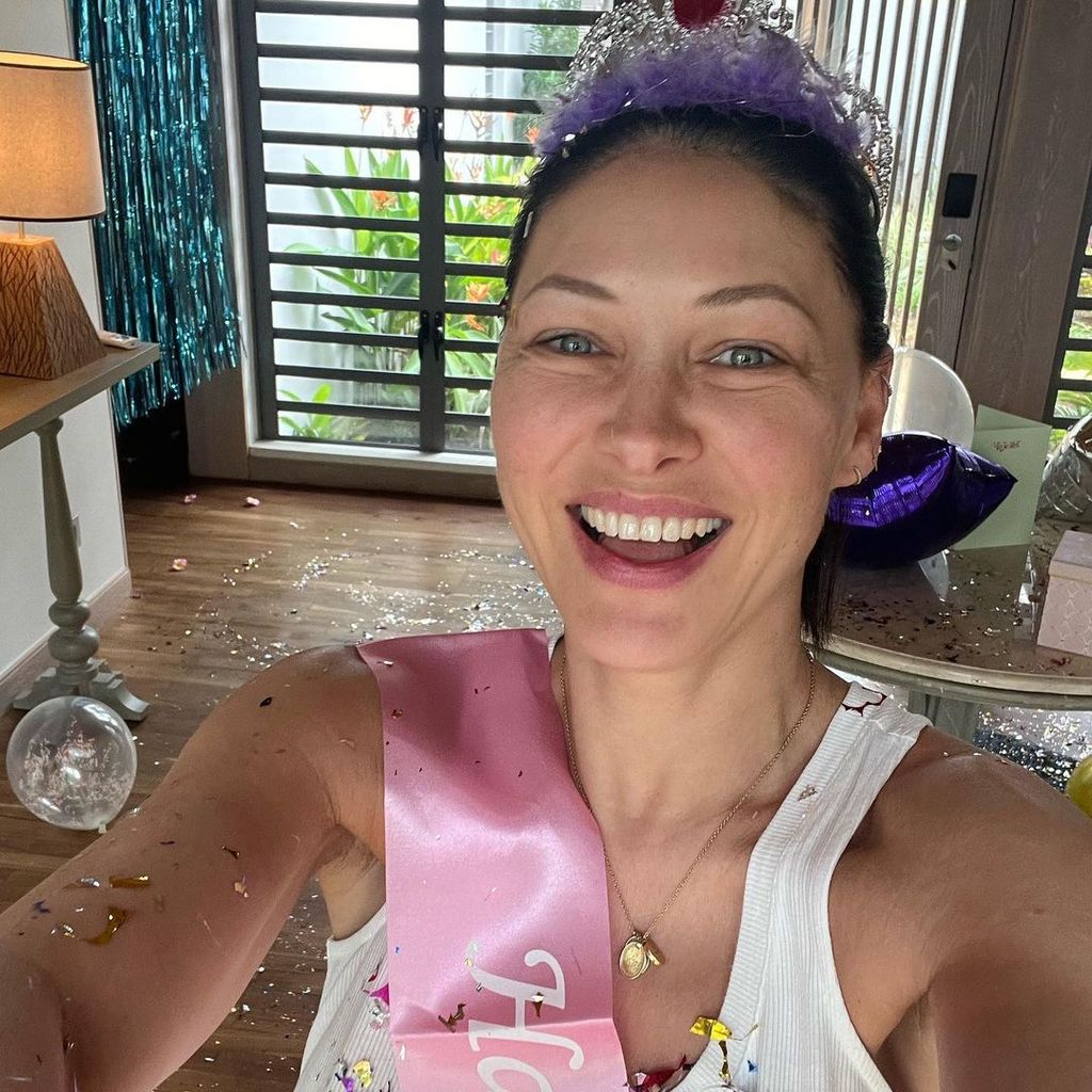 Emma Willis wearing birthday sash and crown to take selfie