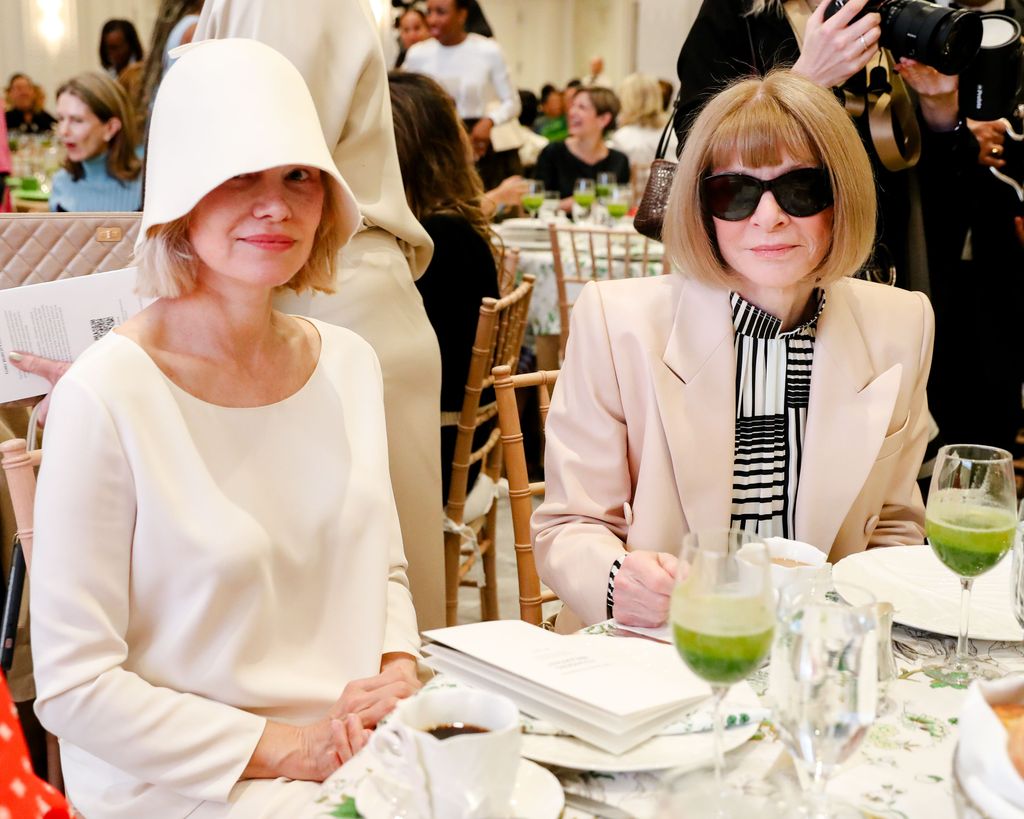 photo of pamela anderson sitting at table with anna wintour