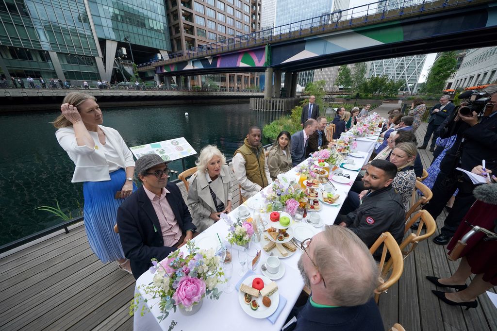 Queen Camilla sitting at lunch table dockside in Canary Wharf
